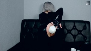 skinny blonde in black latex tries on different anal plugs