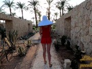 I walk without panties in the garden by the hotel.