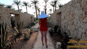 I walk without panties in the garden by the hotel.