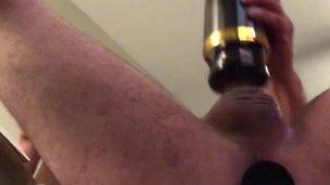 Hot guy strokes his big cock with spinning stroker with plug