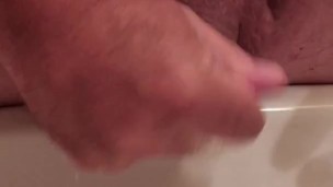 Folding foreskin in underneath itself, simulating circumcision