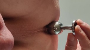 Locked slave plays with butt plug while his mistress is in the kitchen room