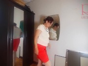 A naked lady does make-up in front of a mirror, puts on underwear, stockings, a skirt. 3 4/16