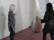 Madame Carla and Amber hang their slaves in a net in the room and kick them together heartily from all sides. 1/16