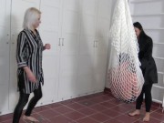 Madame Carla and Amber hang their slaves in a net in the room and kick them together heartily from all sides. 14/16