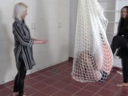 Madame Carla and Amber hang their slaves in a net in the room and kick them together heartily from all sides. 2/16