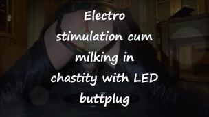 Electro stimulation cum milking in chastity with LED buttplug