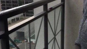 Skinny exhibitionist shows boner on public Toronto balcony while smoking