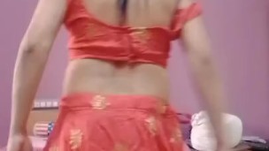 Young Indian bride in a red traditional outfit on the first night.