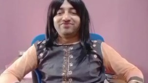 Young sissy crossdresser femboy in a cute little dress on the chair.