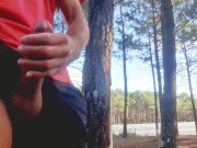 Sexy guy jacking off in public near the road.
