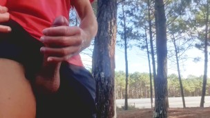 Sexy guy jacking off in public near the road.