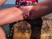 A beauty with a shaved pussy pisses on the sea in the water 9/16