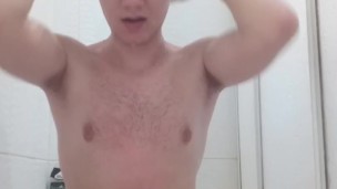 Handsome naked guy takes a shower in front of the camera