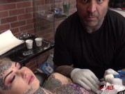 Sascha plays with Amber Luke while she gets tattooed 3/16