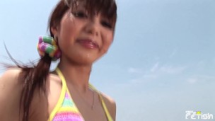Skinny Japanese chick enjoys having a photoshoot on the beach