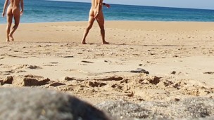 Fitness couple undress on a public beach and masturbate with people watching