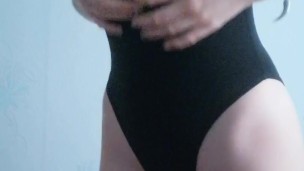 a girl in a bodysuit shows herself