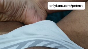 Foot fetish massaging and playing with bulge in white briefs