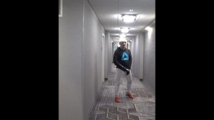 athlete in tights takes his cock out in hotel hall