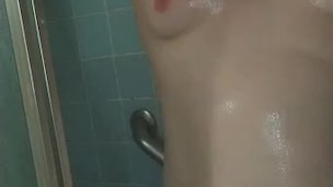 Redhead getting clean in the shower and drying off