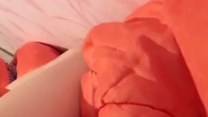 Masturbation squeezing a blanket between legs