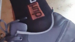 in sneakers and socks on a dildo