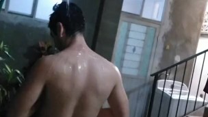 Improvised shower in yard at night