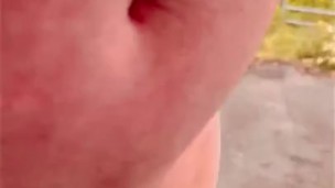 Naked at side of busy road cars passing 