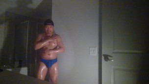 Oiled up and posing while wearing Speedos!