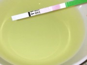 Girl pissing on plate over the toilet and doing an ovulation test 12/16