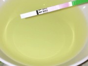 Girl pissing on plate over the toilet and doing an ovulation test 13/16