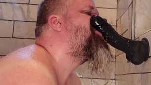 Slave practices cock sucking on dildo