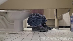 Caged sub offering his hole under the stall