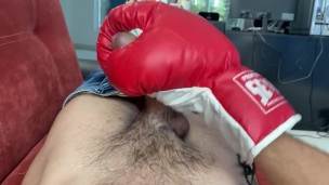 Gay jerking off with boxing gloves.