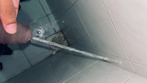 Pissing at the public dirty bathroom edge