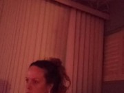 Milf with big boobs showing off cleavage while playing video games and smoking at same time