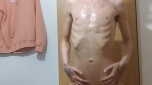 Very skinny horny lad oils up his perfect body and shows off his muscles