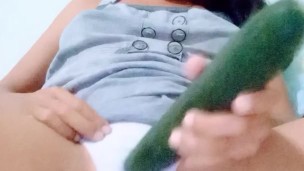 Petite teenager plays with a cucumber 'till reach a orgasm