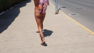 Hot girl walking undresses on a public street and shows off her pussy