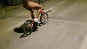 Sexy guy undresses on a public street and rides a bike naked touching his dick - risky