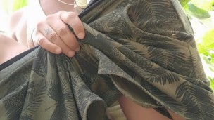 Uncut cock peeing outside in a sitting position without pulling foreskin