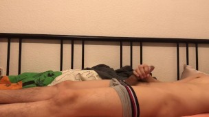 Cute boi humping on his bed cumming in condom