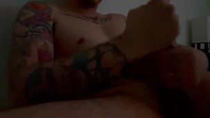 Hot tattooed guy strokes his big cock 