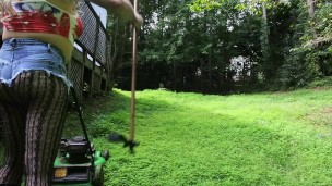 Big fake tits halter top Daisy Dukes wearing crossdresser cutting the grass