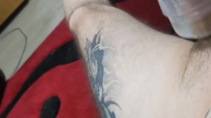 Tattooed guy cums with fleshlight