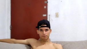 young man masturbates in the living room while the parents do not see him