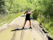 sexy blonde pissing in a puddle on the road 13/16