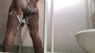 Big ass hairy male doing foam massage in shower