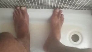 A piss on May male feet in the gym shower 